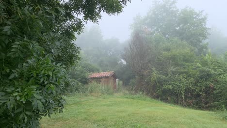 A-small-wooden-cabin-in-the-mountains-amid-thick-fog