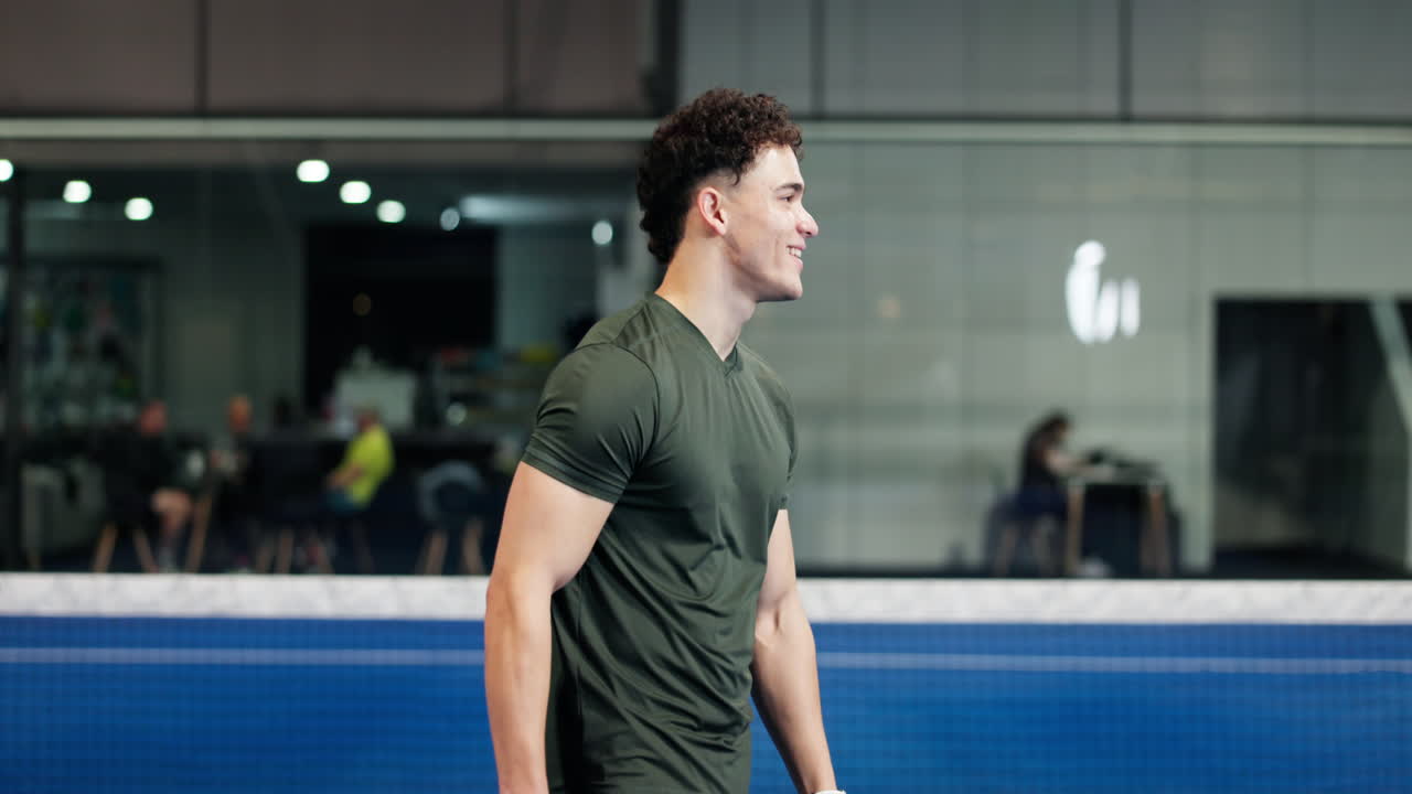 Two friends hugging after playing padel