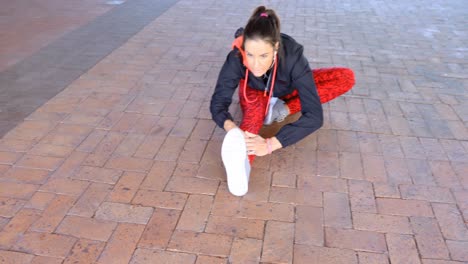 Woman-performing-stretching-exercise-on-footpath-4k