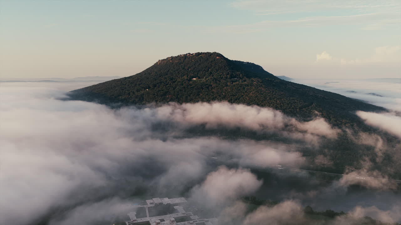 Aerial drone view of Lookout Mountain in Chattanooga, Tennessee, partially covered in mist and clouds