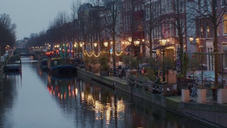un hermoso paisaje cinematográfico vista nocturna de la ciudad de la haya o den haag ciudad con canal, agua y barco barco en los países bajos holandés europeo auténtico estilo de arquitectura tradicional