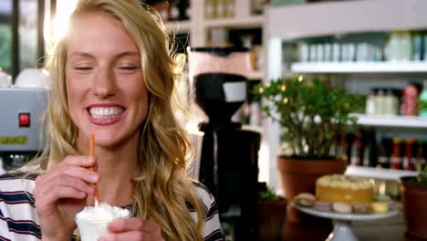 portrait of woman drinking milkshake with a straw