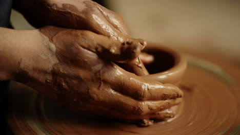 woman hands sculpting clay product in workshop