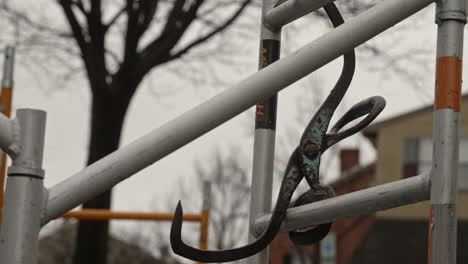 ice tongs hanging from scaffolding, slow motion