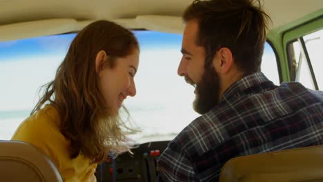 happy young couple interacting with each other in van 4k
