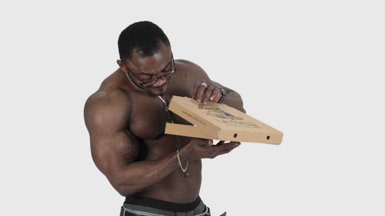Muscular man holding pizza. Athletic handsome naked body of african man with pizza