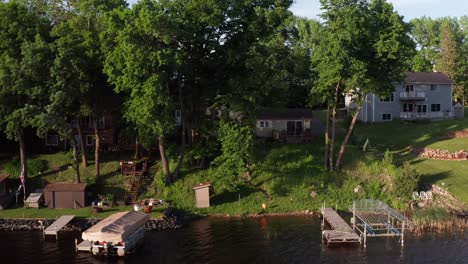 low aerial dolly shot across lakefront houses in minnesota