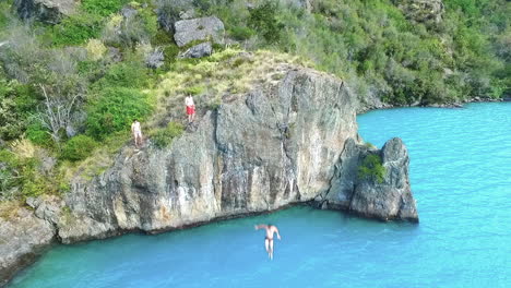 aerial - diving into the turquoise waters of general carrera lake, chile