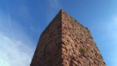 red colour guard tower of ruins of the three castles of eguisheim on a beautiful clear day