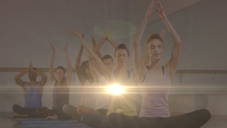 Animation-of-glowing-light-over-people-practicing-yoga