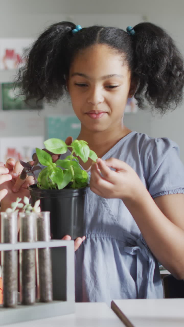 Video of happy african american male teacher and class of diverse pupils during biology lesson