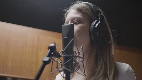 beautiful female singer working in music studio