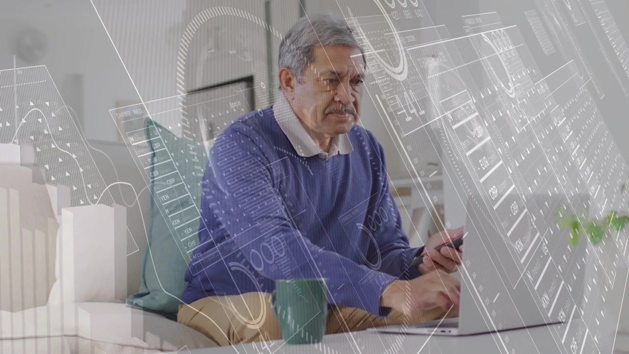 Senior man tapping smartphone, leaning toward laptop on sofa, analyzing tech with overlaying charts