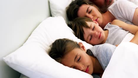 Family-sleeping-in-bedroom