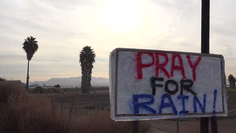 Un-Letrero-Dice-Rezar-Por-La-Lluvia-A-Lo-Largo-De-Una-Carretera-De-California-Durante-Una-época-De-Sequía