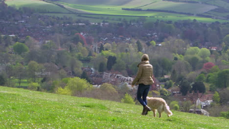 rear view of woman taking dog for walk shot on r3d