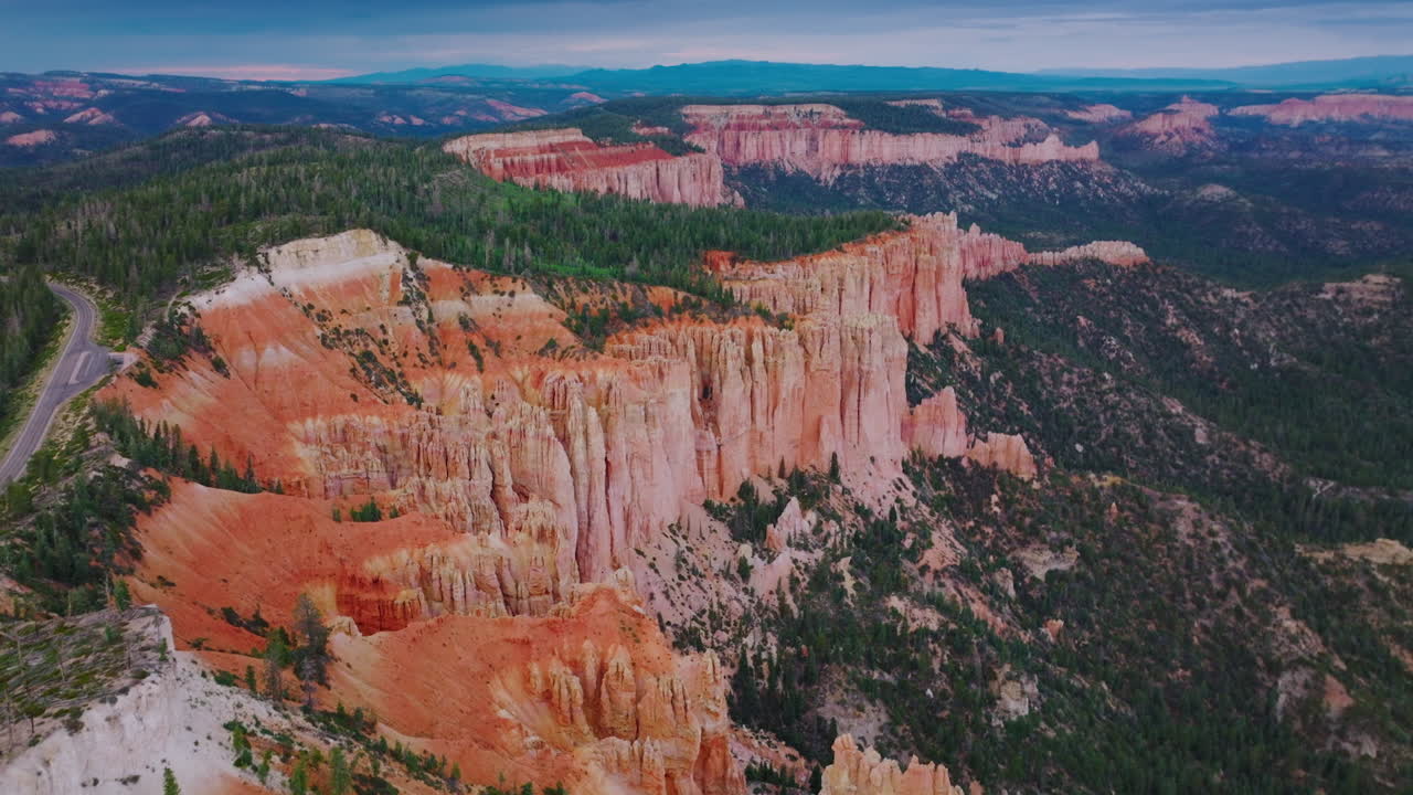 Splendid scenic view of Bryce Canyon. Endless mountainous territory overgrown with pine trees. Aerial perspective.
