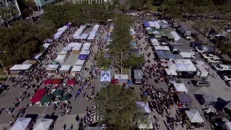 4k aerial drone video of shoppers at farmers market in downotwn st