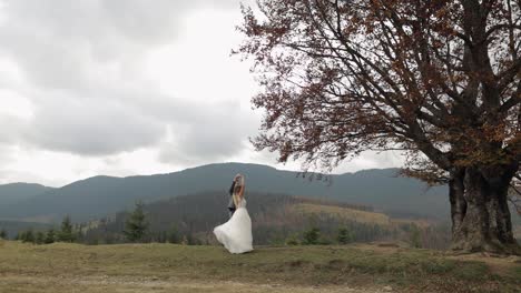 Lovely-newlyweds-bride-groom-dancing-on-mountain-autumn-slope-in-slow-motion,-wedding-couple-family