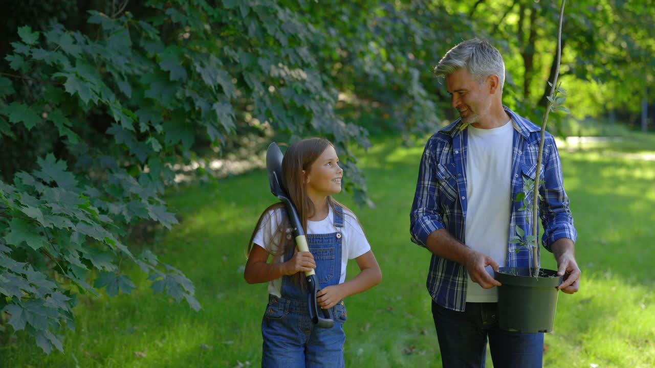 Father and Daughter Planting a Tree
