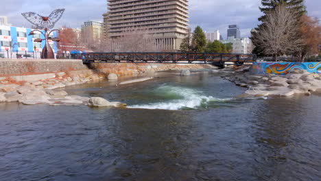 push over rapids and towards and over pedestrian bridge on the truckee river in downtown reno, nevada