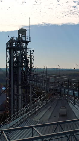 modern industrial plant on nature background. metal construction of agricultural factory. exterior of large manufacture. aerial view. vertical video