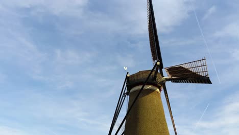 close up of a moving tradtional dutch windmill in the countryside of the netherlands