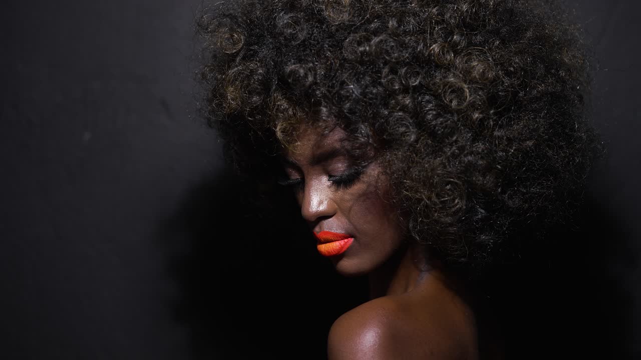 African American Woman with Curly Hair and Orange Lipstick
