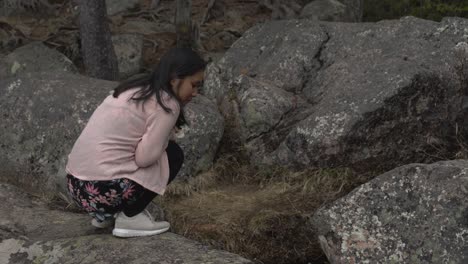 girl looking at something in the forest