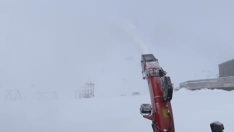 autonomous snowblower robot clearing snow high up in the cloudy alps of austria