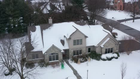 large suburban house decorated for christmas, covered in fresh cold snow