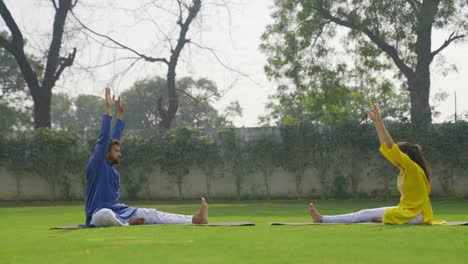 Indian-couple-doing-head-to-knee-yoga-pose