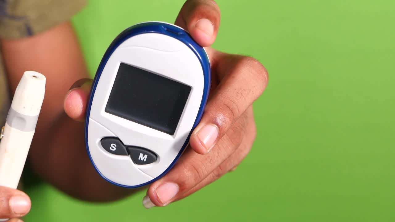 Person holding a blood glucose meter