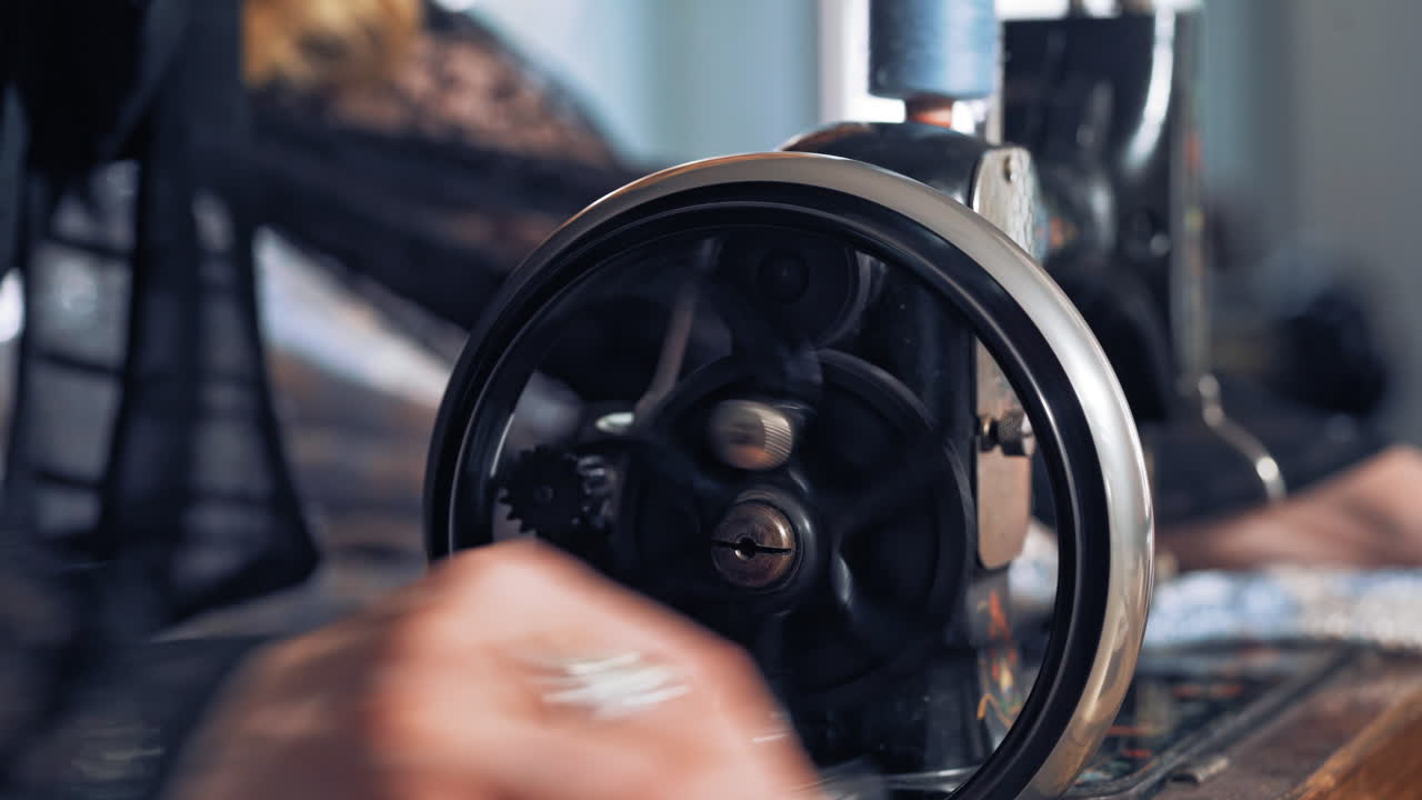 Dressmaker work on sewing machine. Close up of woman seamstress work on the sewing machine