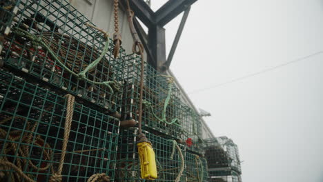lobster traps and fisherman's gear with misty foggy sky in new england 4k 60p