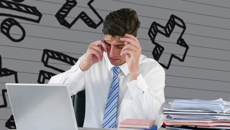 man using laptop against mathematical symbols on white lined paper