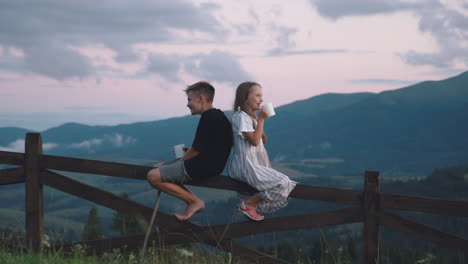 siblings enjoying a mountain view at sunset