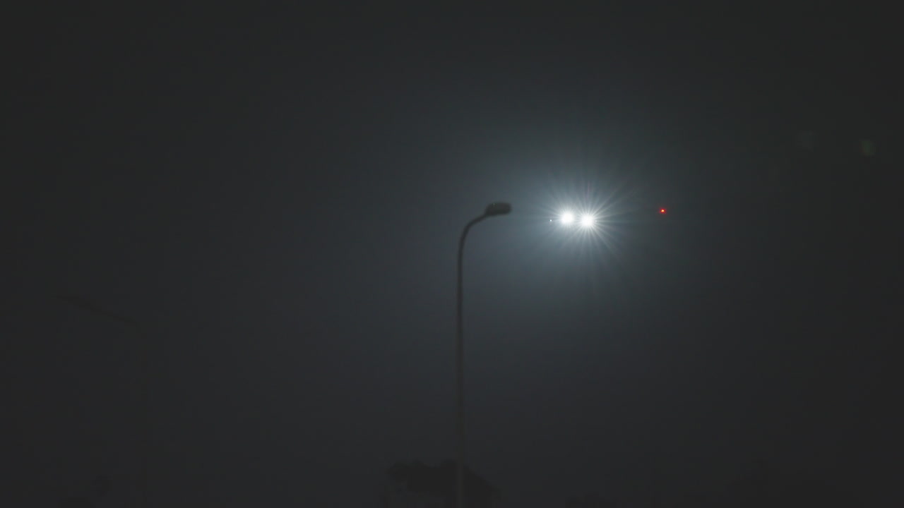 Commercial Jet Landing on Runway at Night Through Fog