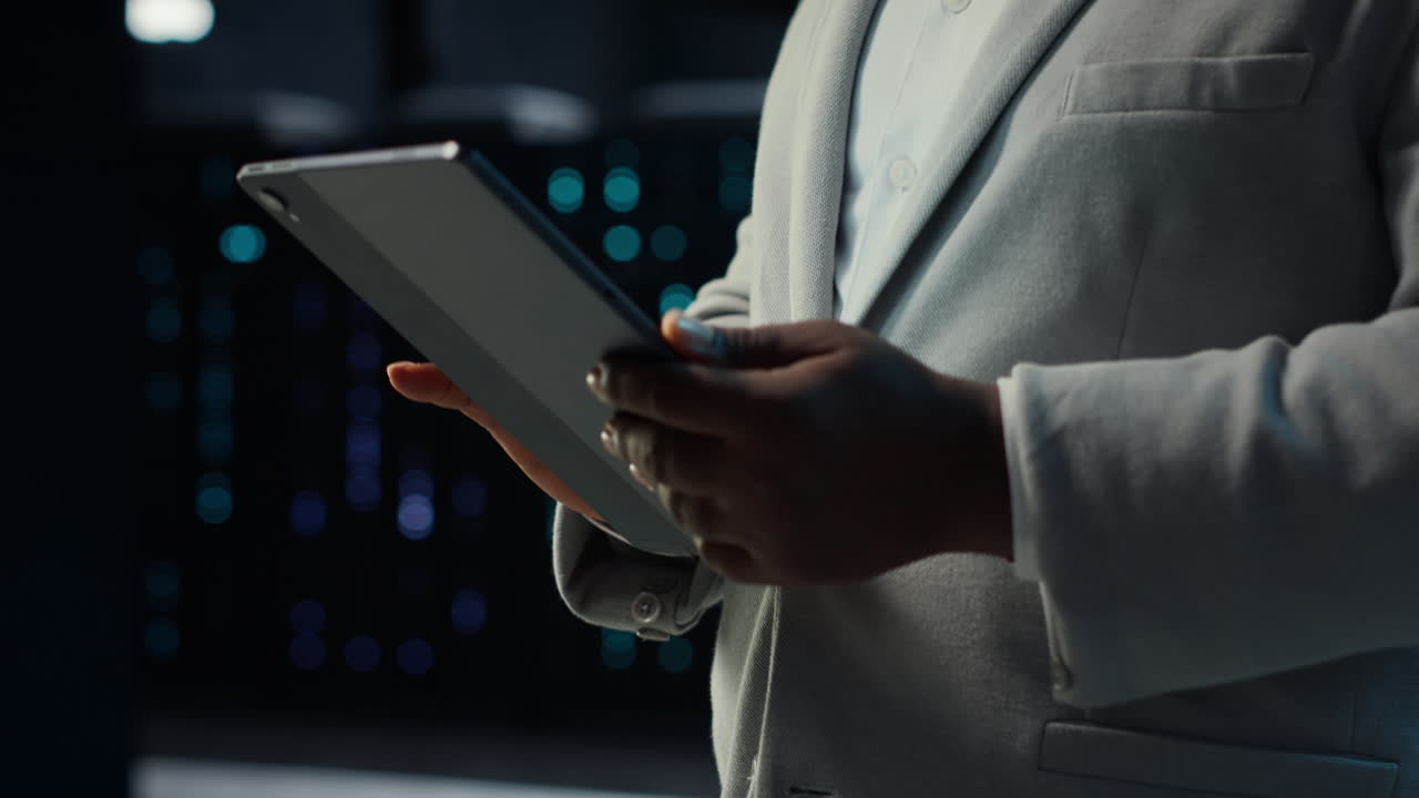 Vertical video IT professional in server hub ensures data remains shielded from threats