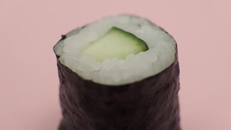 Sushi-roll-rotating-on-rosy-background