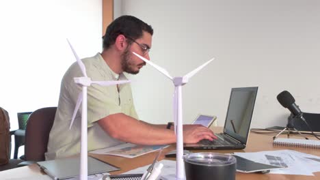 side view of a male professional typing on a laptop computer