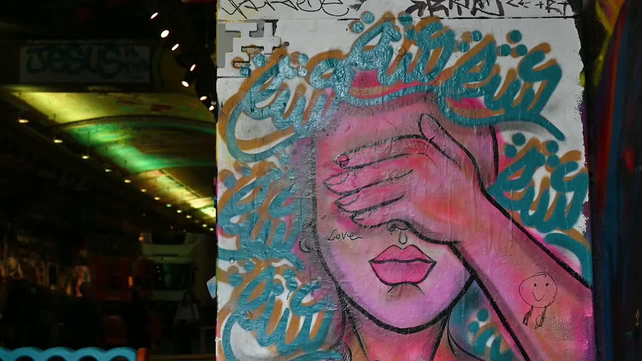 Street Art Mural of a Woman Covering Her Eyes