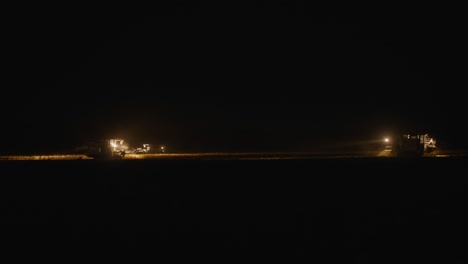 massive rice field mechanized harvesting at night