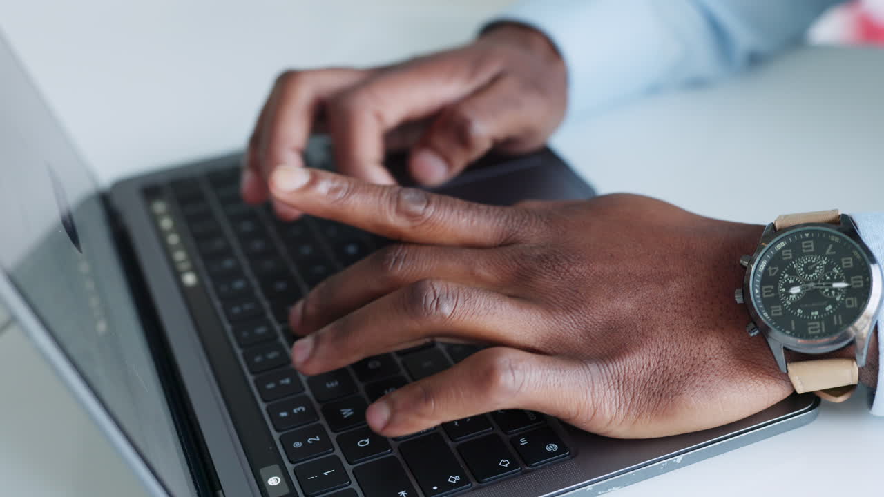Close up of hands typing on keyboard of laptop