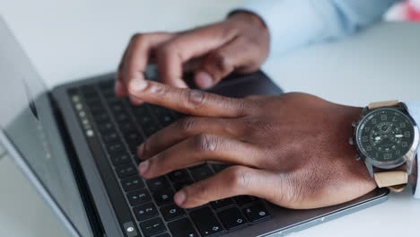 Close-up-of-hands-typing-on-keyboard-of-laptop