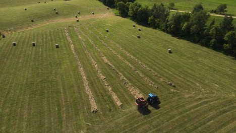 Farmer-On-Wheel-Tractor-Baling-Hay-In-The-Countryside