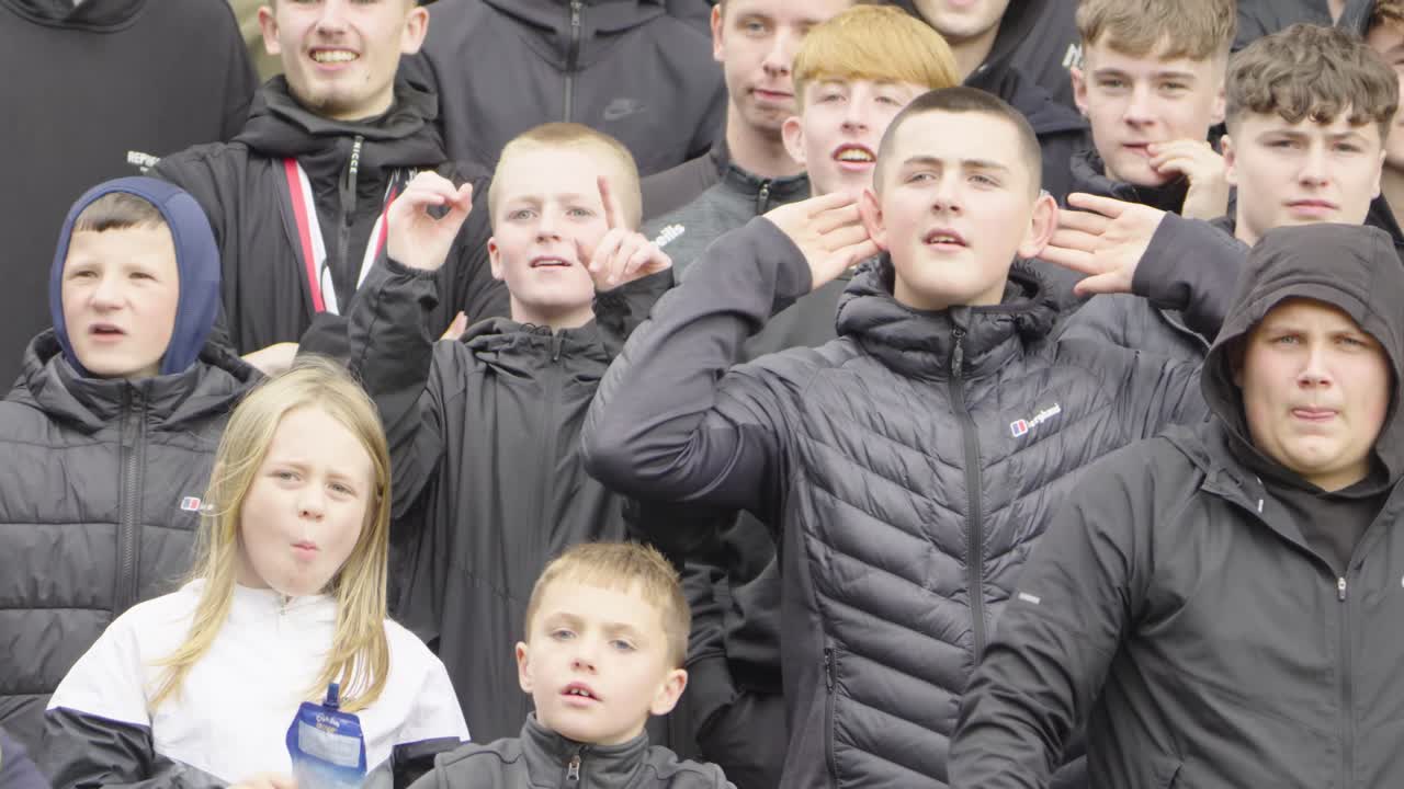 Teenage Soccer supporters gesturing, stadium rivals, Scottish Football