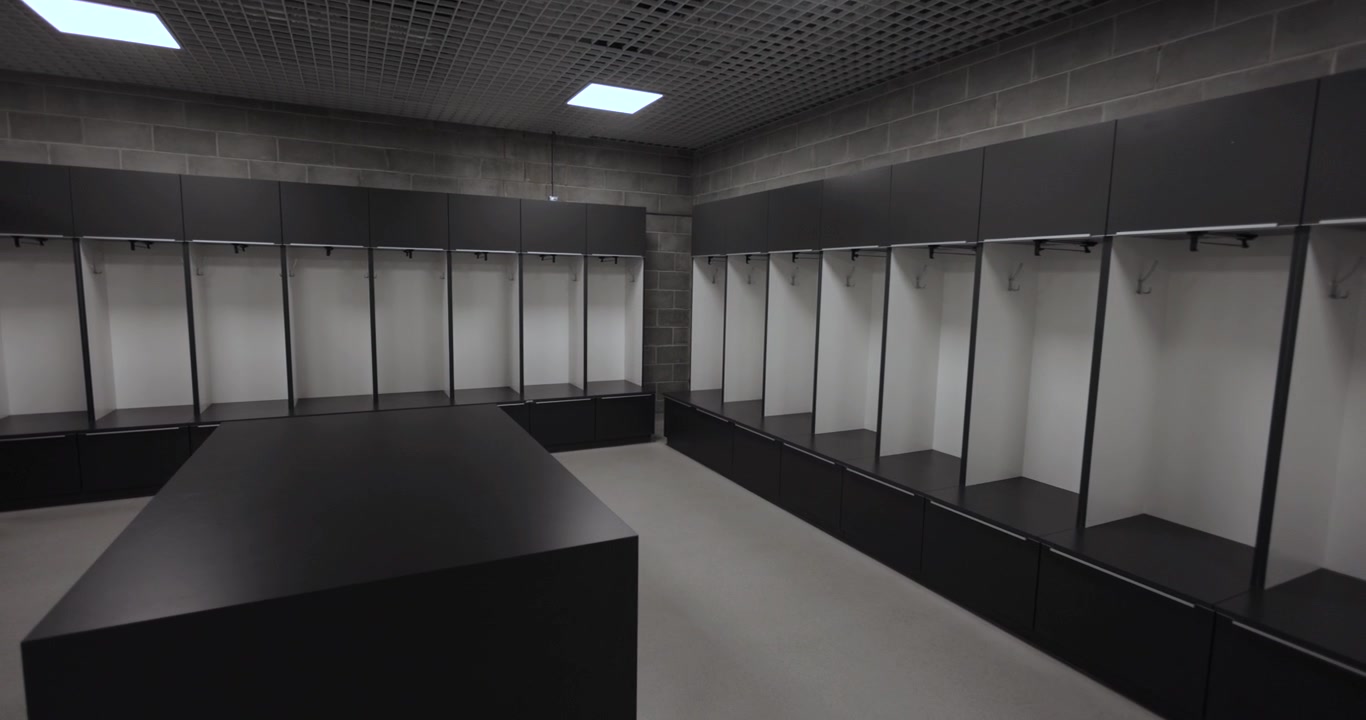Empty European football team's locker room, dynamic wide angle 4K shot