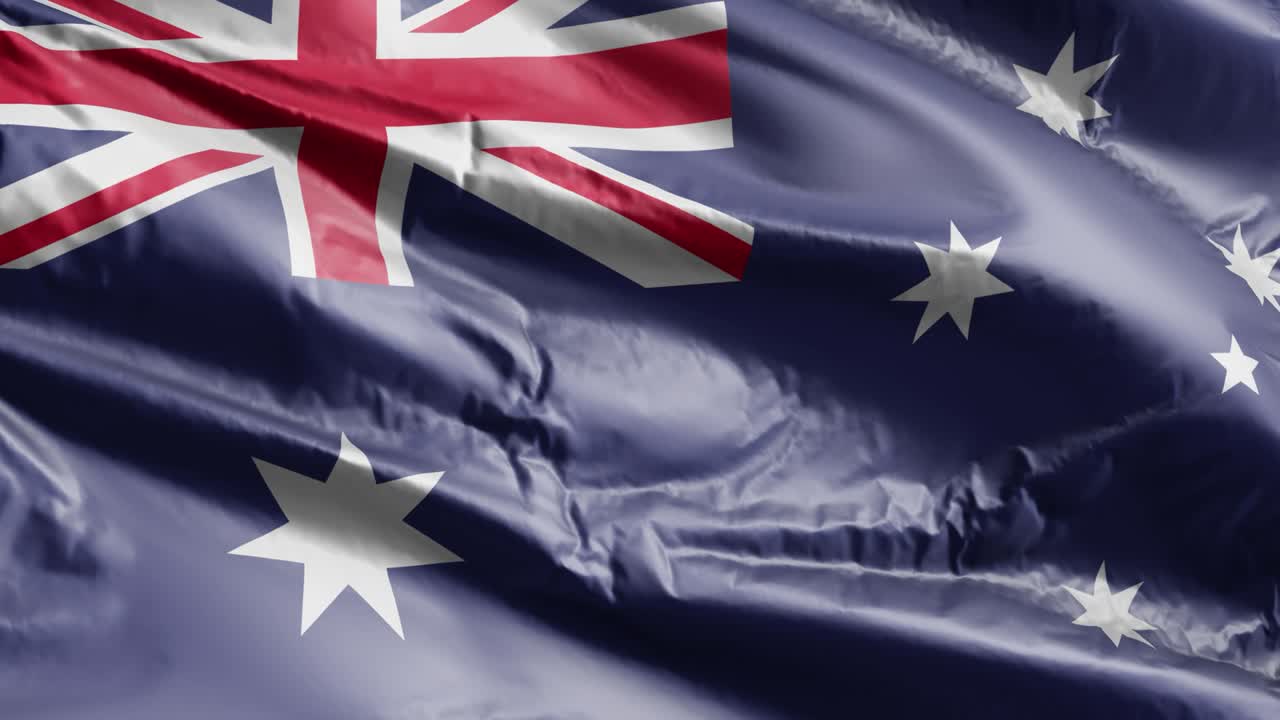 la bandera de australia se agita lentamente en el bucle del viento. la bandera australiana se balancea suavemente en la brisa. el fondo de relleno completo. 20 segundos de bucle.