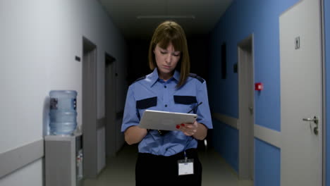 woman in uniform walking on the hallway